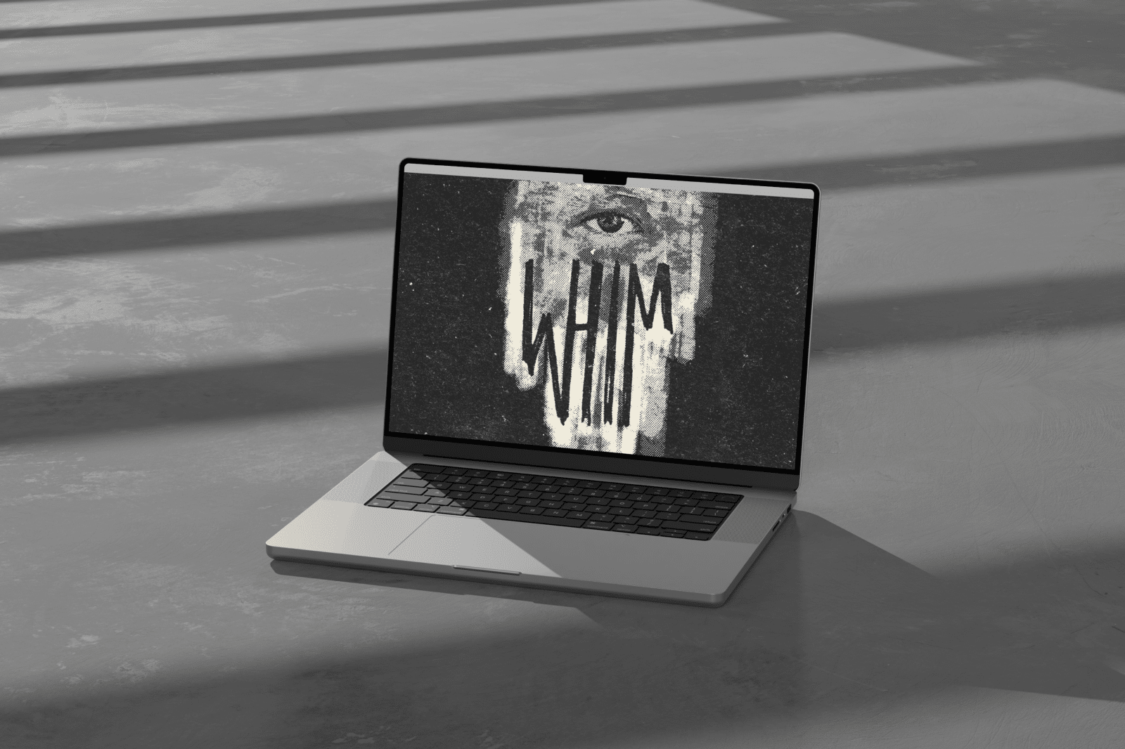 laptop with "whim" logo