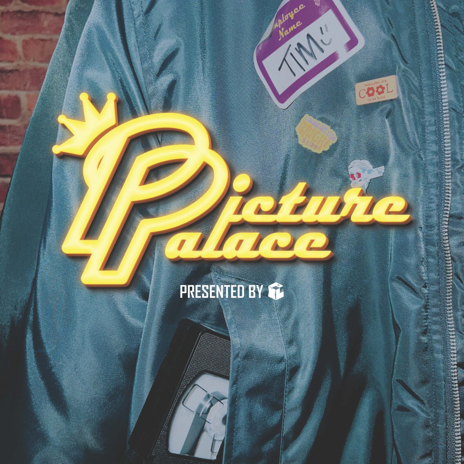 Retro turquoise 80s jacket, with video store employee sticker name badge, cassette tape in pocket, and film title "Picture Palace" in neon sign typeface. 